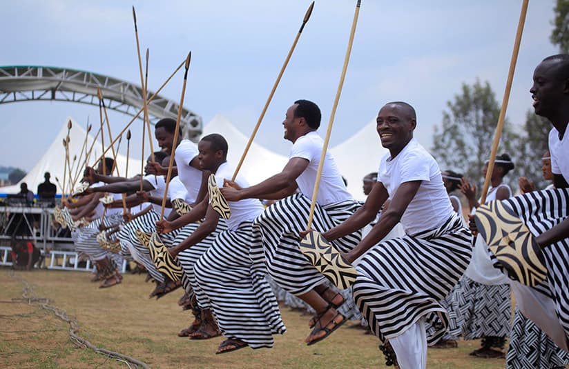 Rwandan traditional dancers in inkanda leaping in unison with ceremonial shields