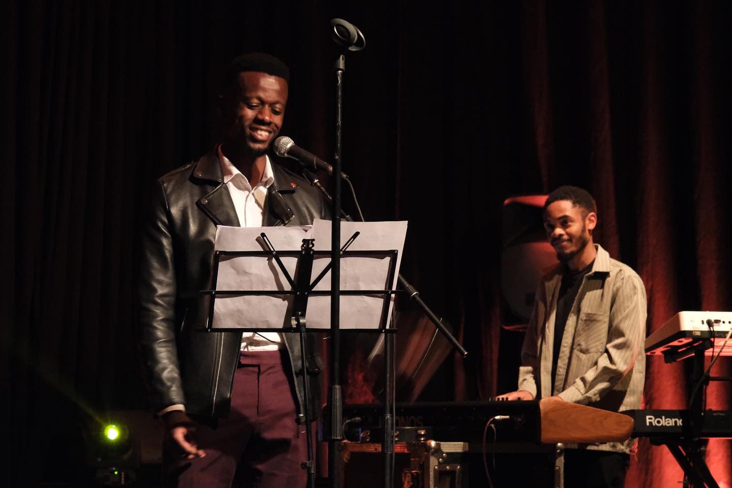Young Rwandan artist performing live with keyboard accompanist in rehearsal showcase